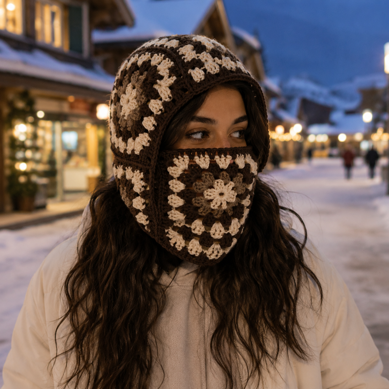 Granny Square Crochet Balaclava worn in a snowy alpine village at dusk